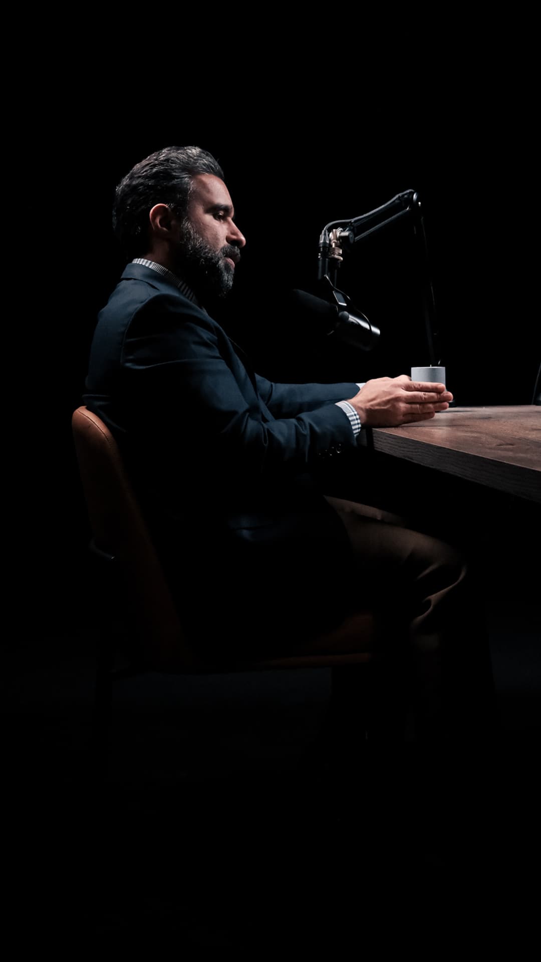 Prof. Jamal recording a podcast episode in a dark studio