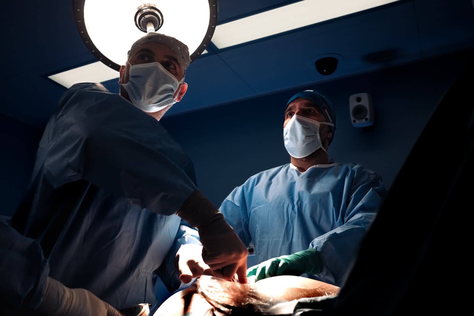 Prof. Jamal operating with a colleague under the surgical lights